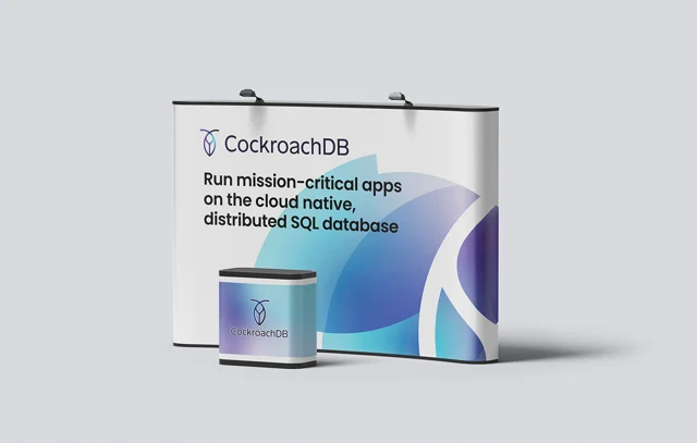 CockroachDB exhibition backdrop and counter with coordinated blue and violet graphic shapes